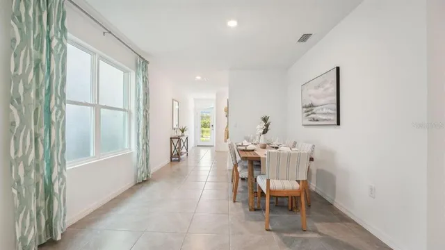 a dining room with furniture and window