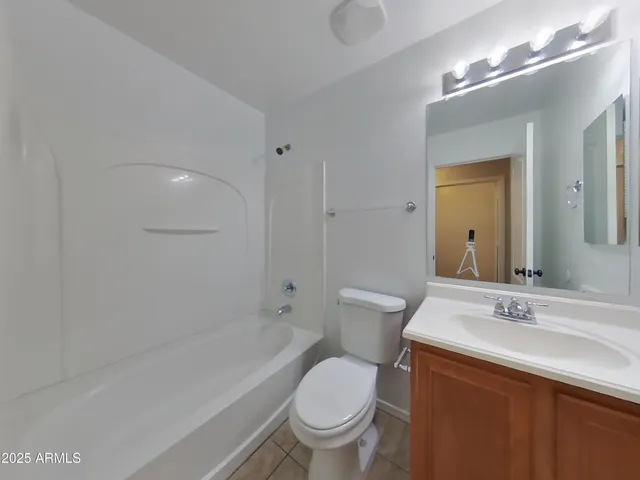 a white toilet sitting next to a bath tub