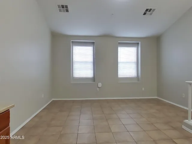 a view of a room with a ceiling fan and window