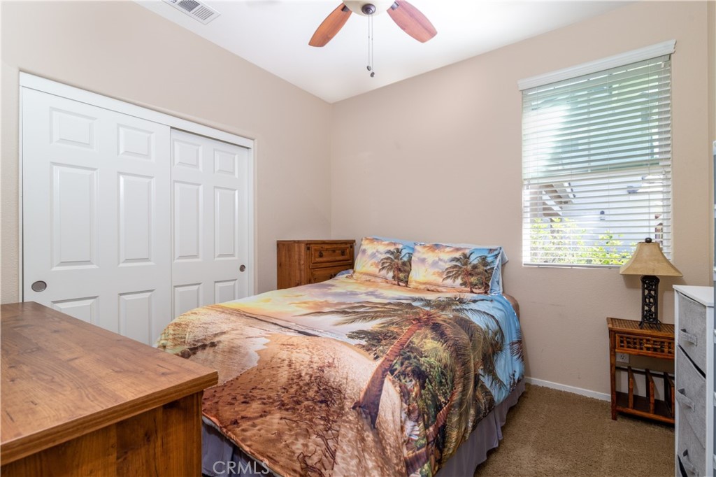 27336 Brandon Lane Temecula, CA 92591 - Photo 20 of 49 a bedroom with a bed and a chandelier