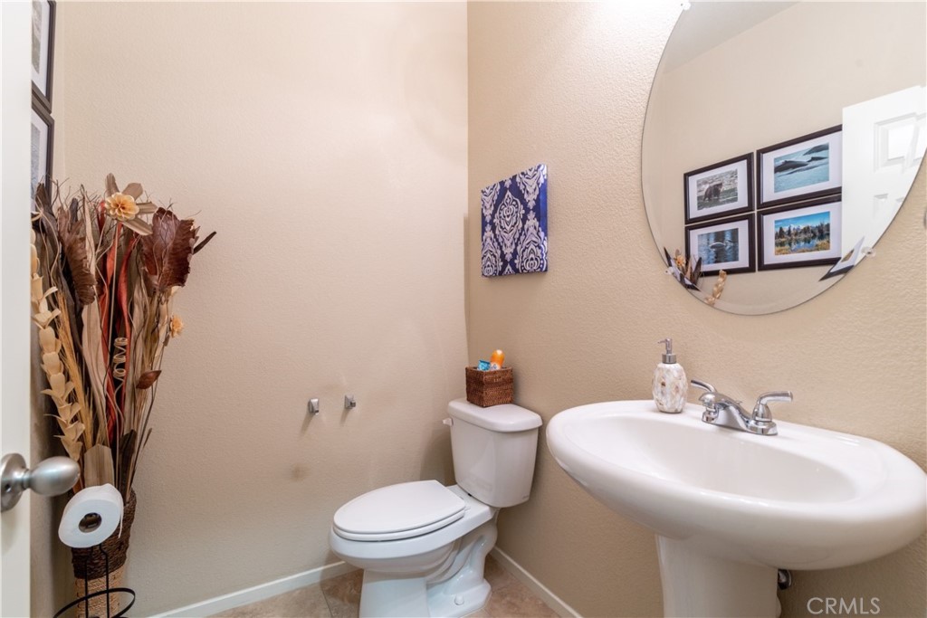 27336 Brandon Lane Temecula, CA 92591 - Photo 23 of 49 a bathroom with a toilet sink and mirror