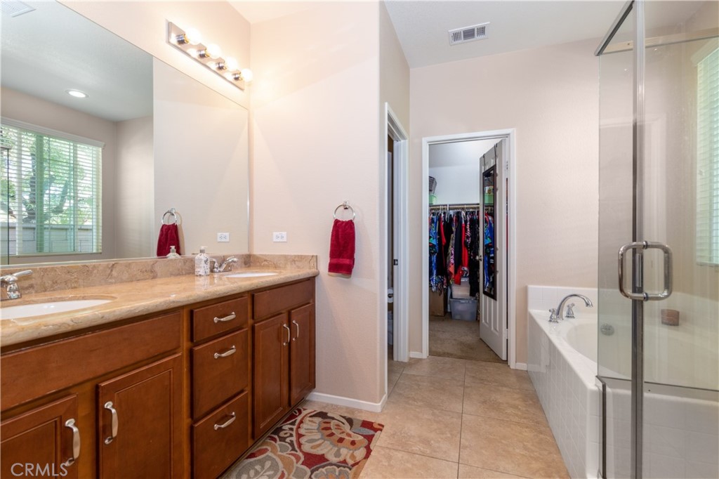 27336 Brandon Lane Temecula, CA 92591 - Photo 27 of 49 a en suite bathroom with a granite countertop sink and mirror