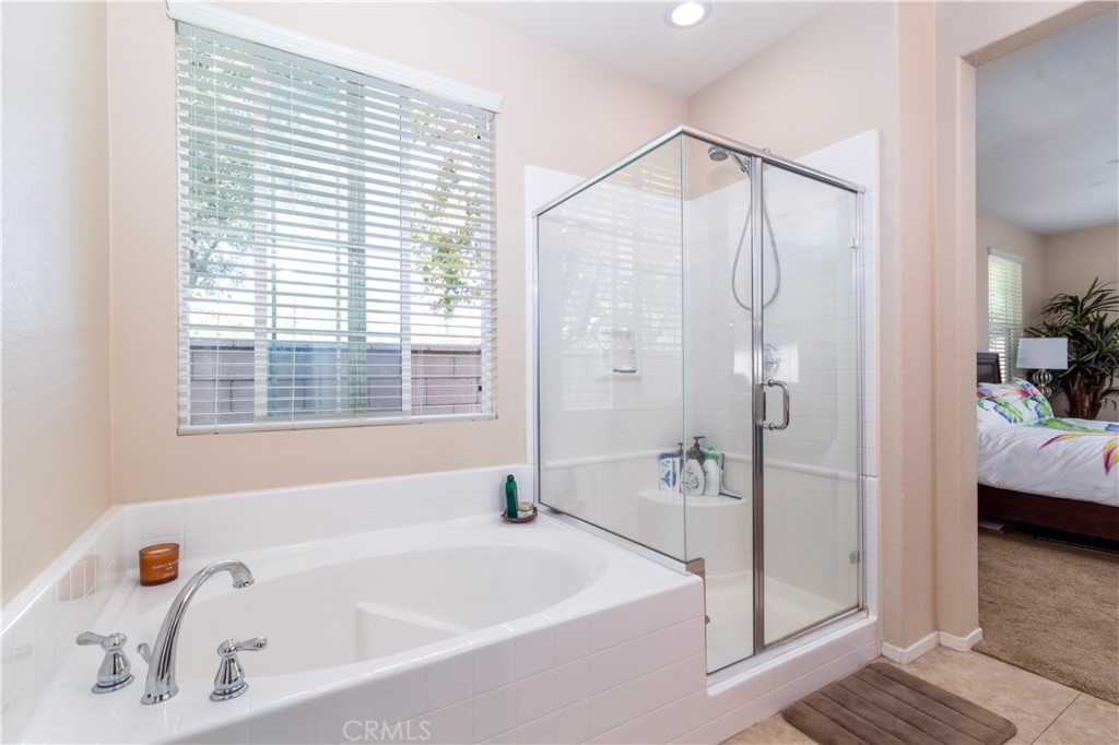27336 Brandon Lane Temecula, CA 92591 - Photo 28 of 49 a bathroom with a bathtub and a shower
