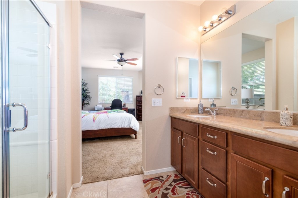 27336 Brandon Lane Temecula, CA 92591 - Photo 29 of 49 a en suite bathroom with a double vanity sink a mirror and a shower