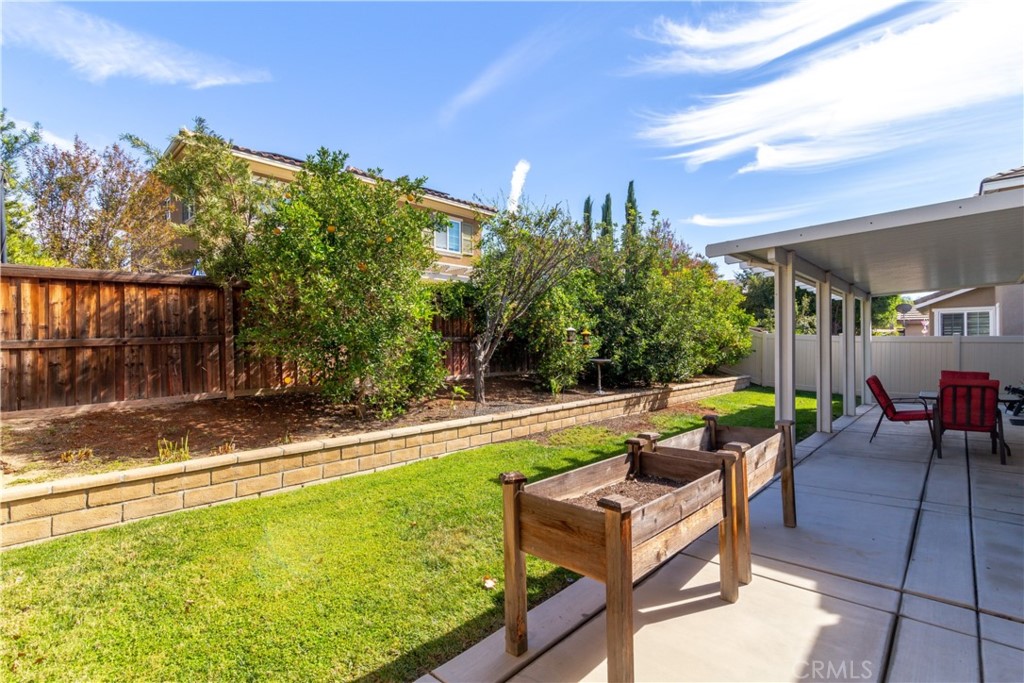 27336 Brandon Lane Temecula, CA 92591 - Photo 30 of 49 a view of a patio with couches and table and chairs with wooden fence