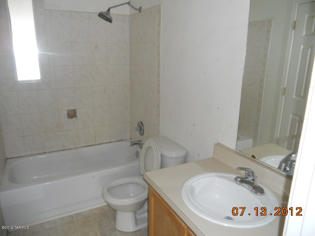 3516 South Mission Road, Unit 1 Tucson, AZ 85713 - Photo 7 of 9 a bathroom with a sink a toilet and a bathtub