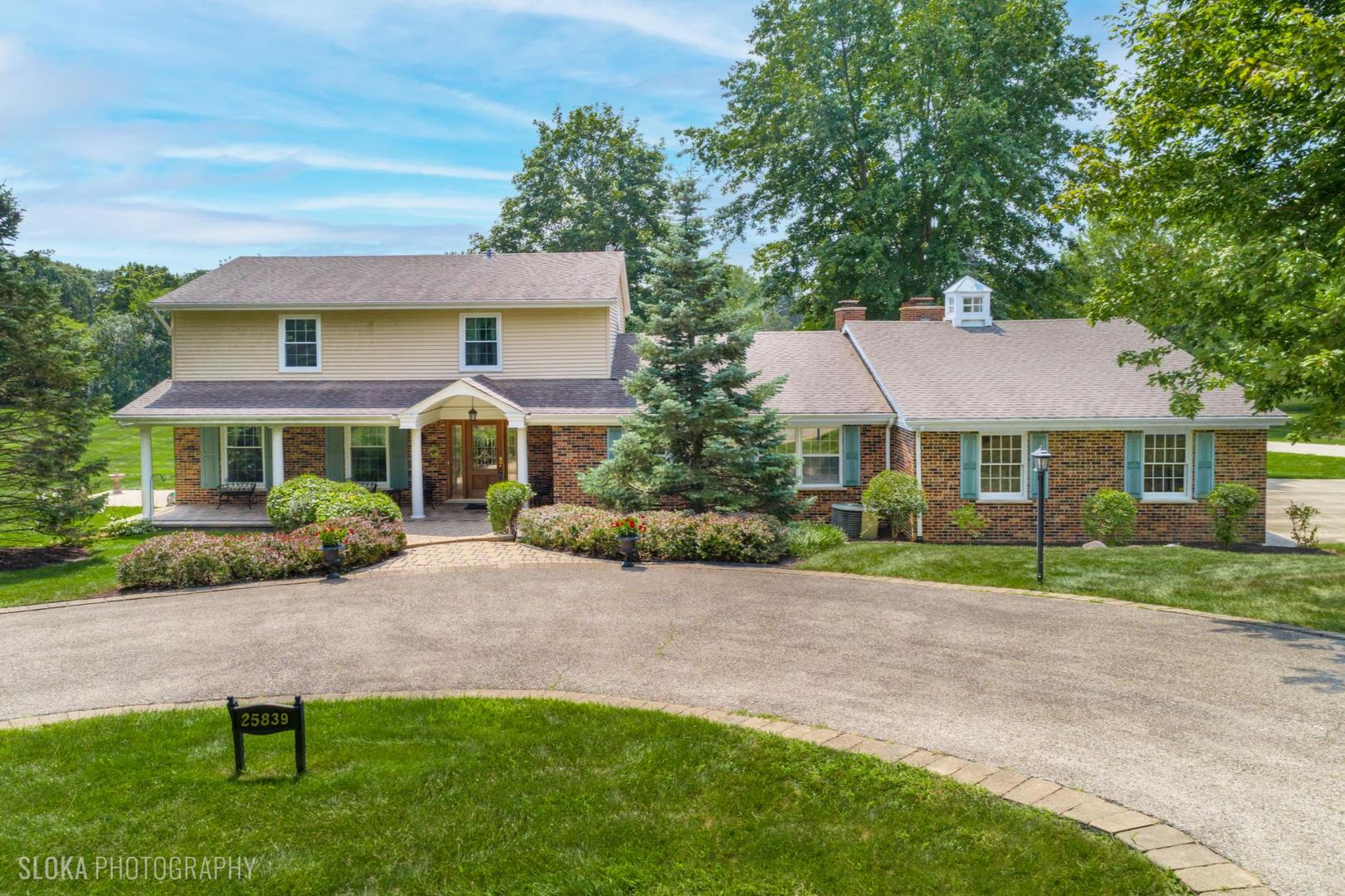 25839 West Sunset Road Barrington, IL 60010 - Photo 1 of 54 a front view of a house with a yard and porch