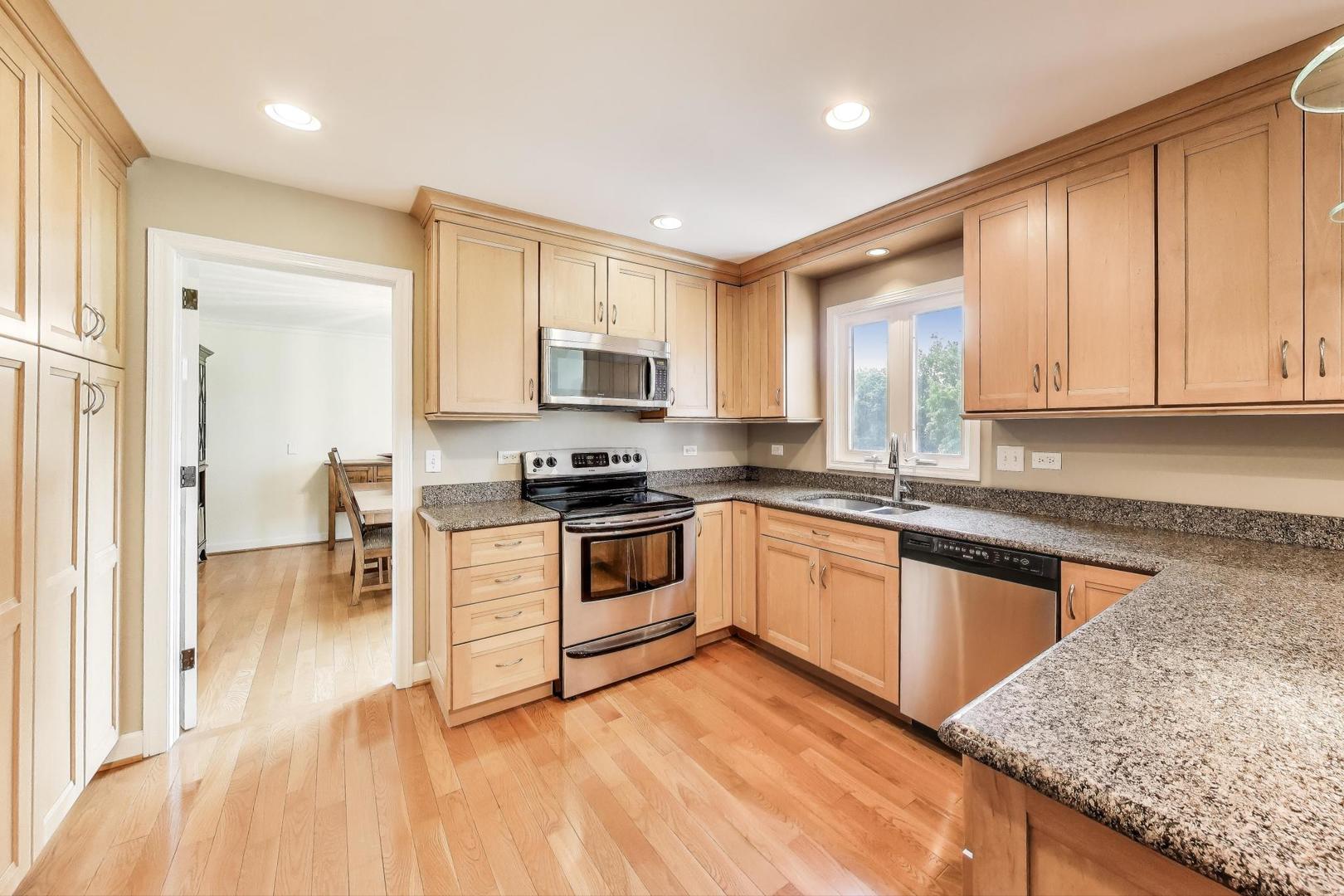 25839 West Sunset Road Barrington, IL 60010 - Photo 13 of 54 a kitchen with granite countertop a stove a sink and a microwave