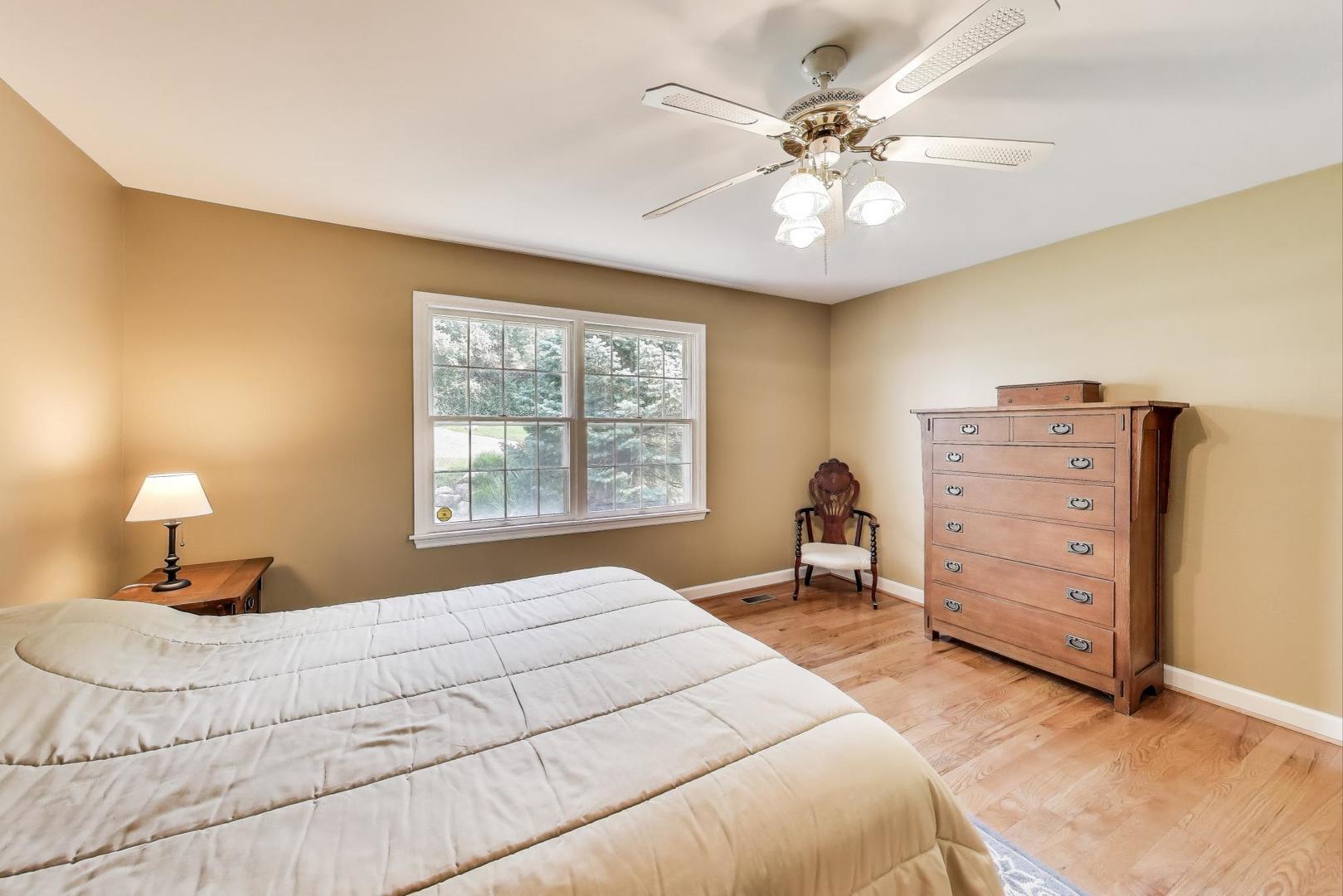 25839 West Sunset Road Barrington, IL 60010 - Photo 20 of 54 a bedroom with a bed and a chandelier