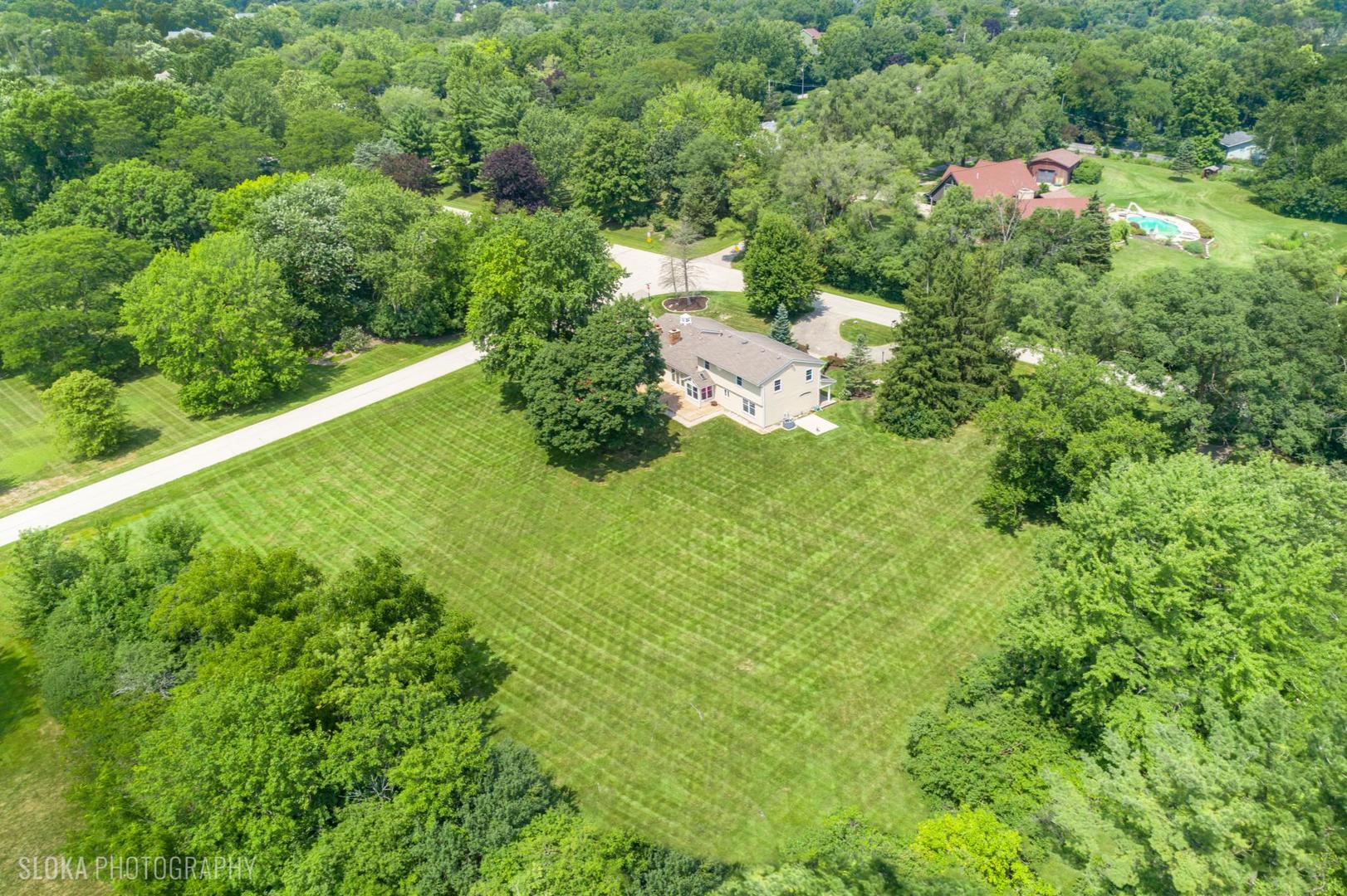 25839 West Sunset Road Barrington, IL 60010 - Photo 2 of 54 a view of a house with a yard