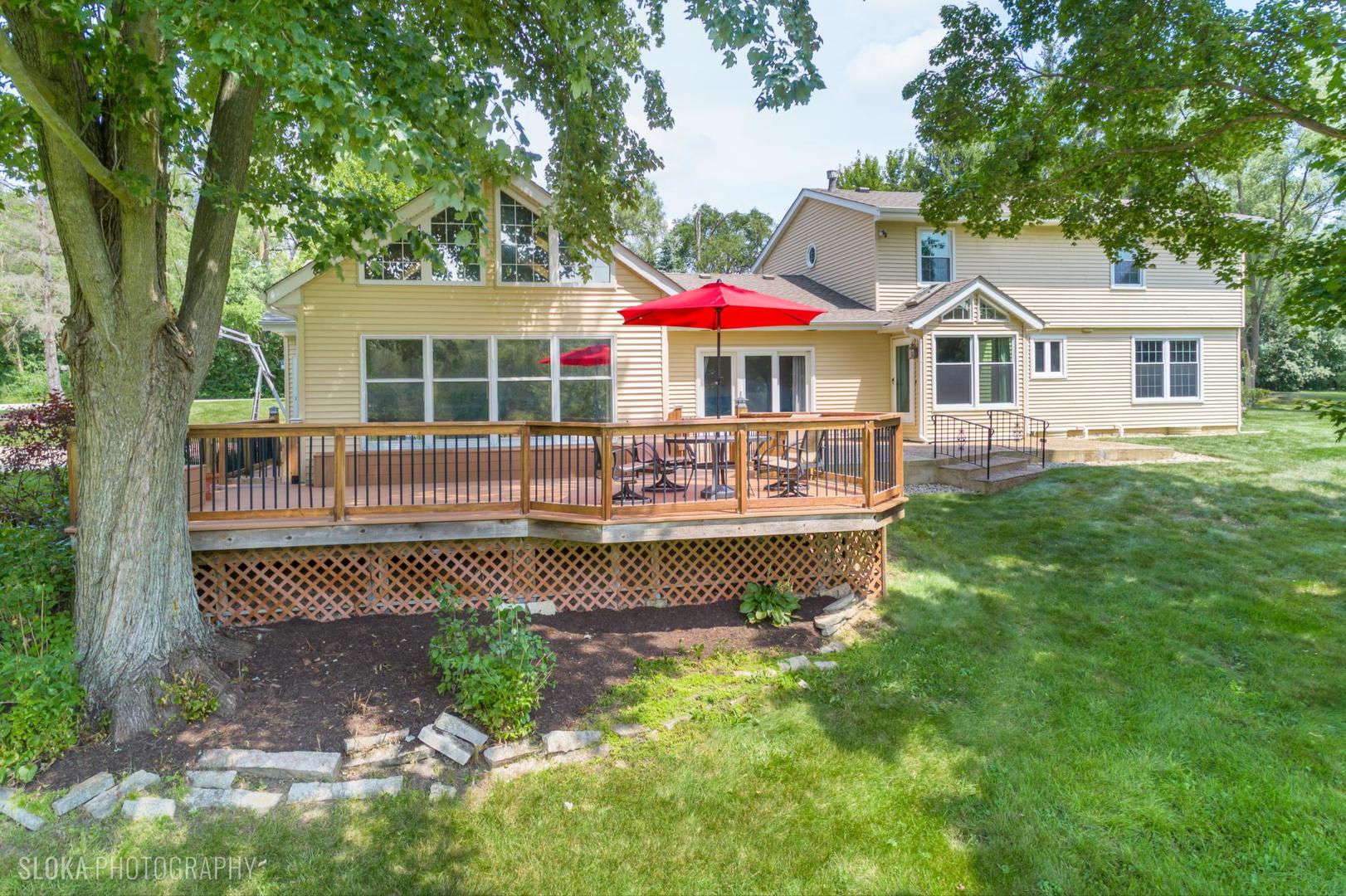 25839 West Sunset Road Barrington, IL 60010 - Photo 34 of 54 a front view of a house with a yard table and chairs
