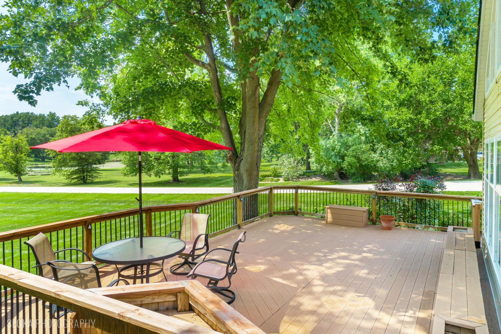 25839 West Sunset Road Barrington, IL 60010 - Photo 38 of 54 a view of a deck with a table and chairs under an umbrella