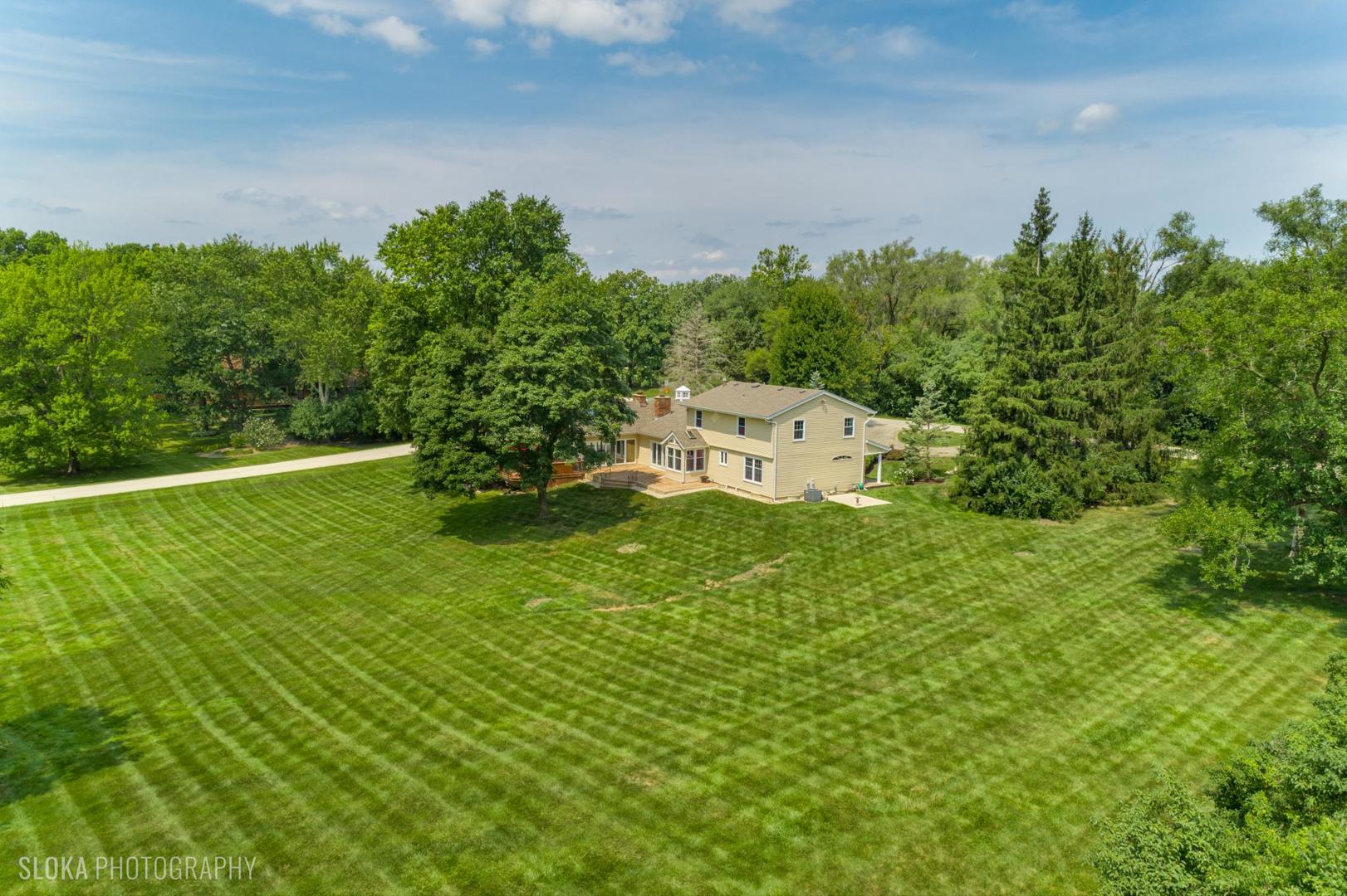 25839 West Sunset Road Barrington, IL 60010 - Photo 48 of 54 a view of a big yard with potted plants and large tree