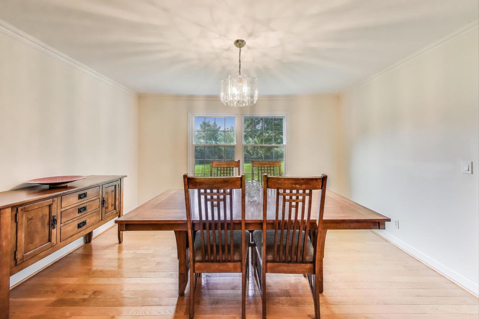 25839 West Sunset Road Barrington, IL 60010 - Photo 10 of 54 a view of a dining room with furniture window and wooden floor
