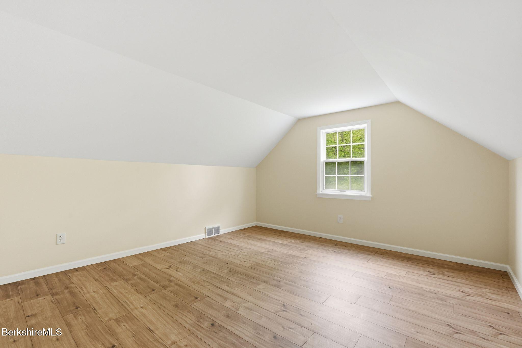 98 N Road Monroe, MA 01247 - Photo 26 of 32 an empty room with wooden floor and windows