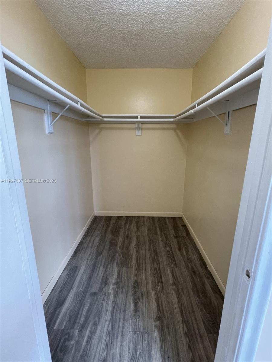 1720 North Congress Avenue, Unit 310 West Palm Beach, FL 33401 - Photo 15 of 18 a view of a room with wooden floors and white walls