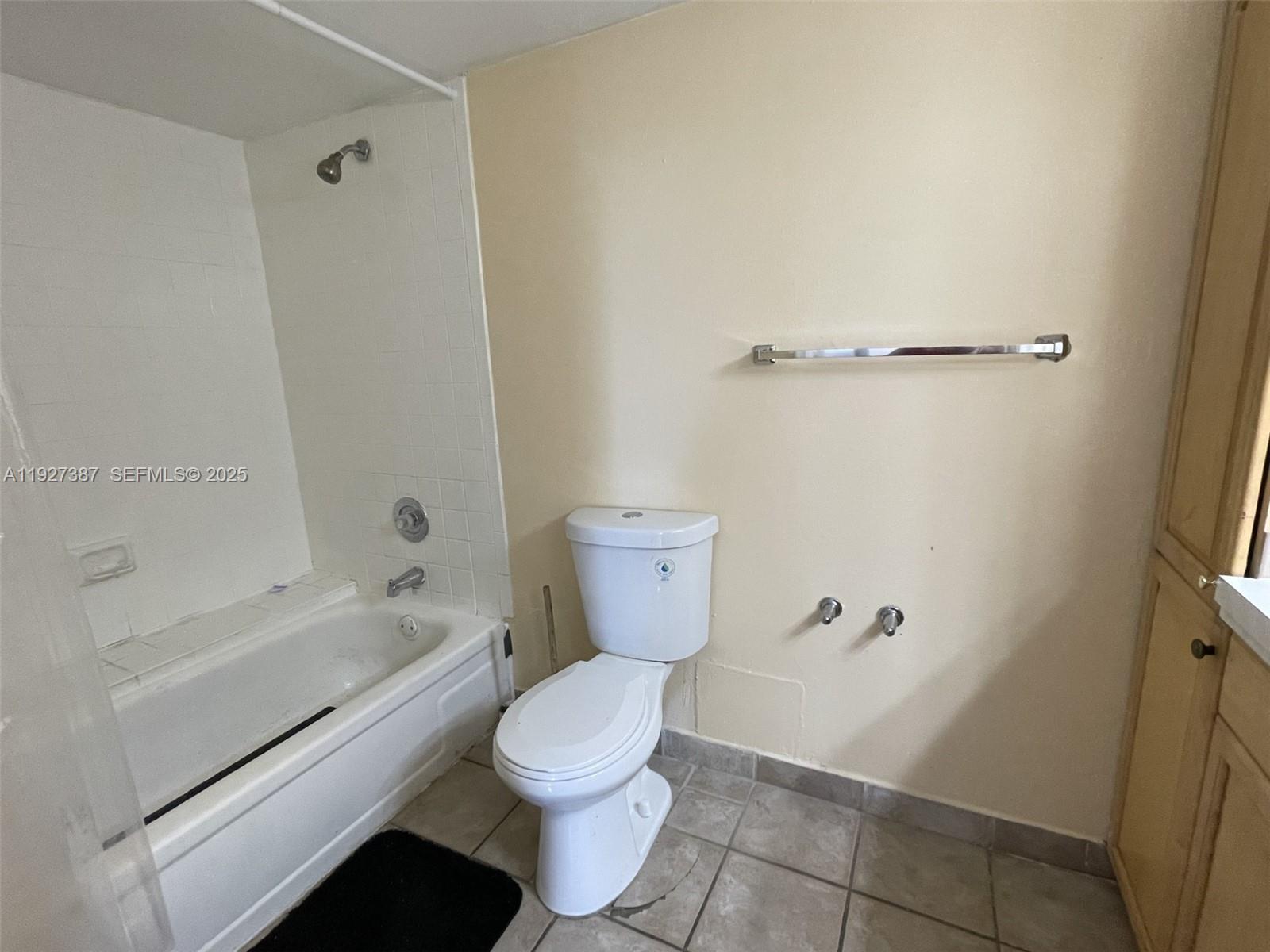 1720 North Congress Avenue, Unit 310 West Palm Beach, FL 33401 - Photo 17 of 18 a bathroom with a toilet and a shower
