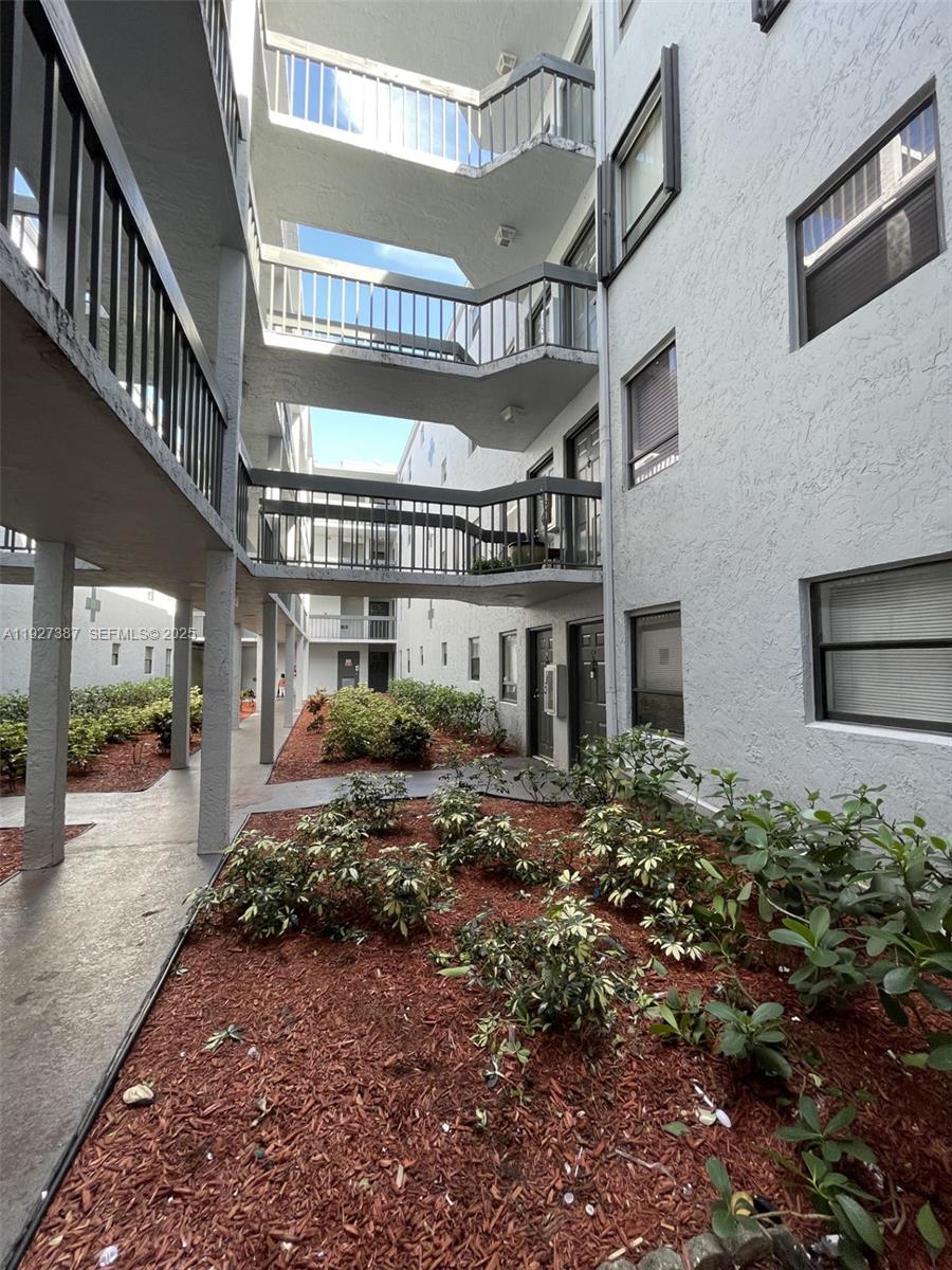 1720 North Congress Avenue, Unit 310 West Palm Beach, FL 33401 - Photo 3 of 18 a view of a building with a porch