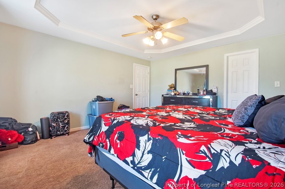 10 Pender Road Spring Lake, NC 28390 - Photo 22 of 35 a bedroom with a bed and a chandelier
