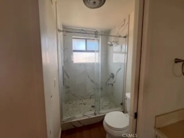 a bathroom with a toilet a sink and shower