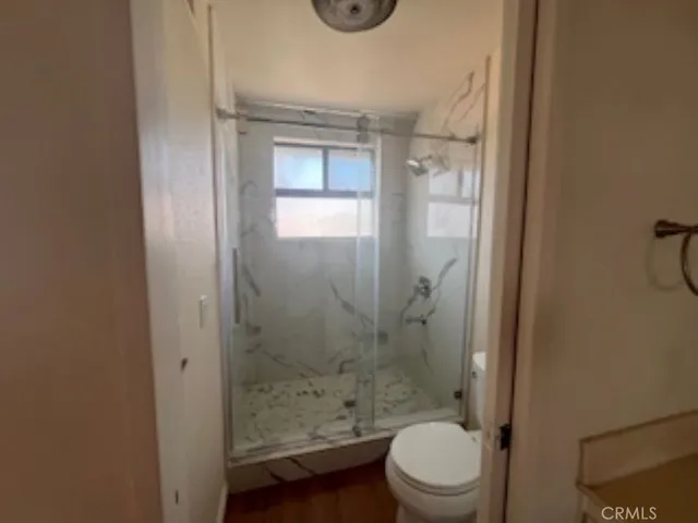 a bathroom with a toilet and a shower
