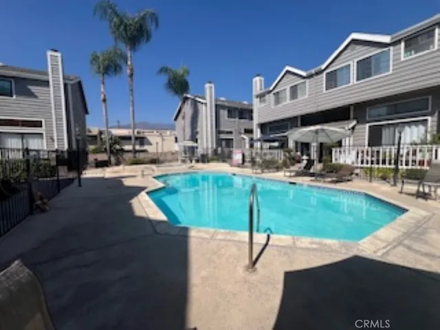 a swimming pool with outdoor seating and yard