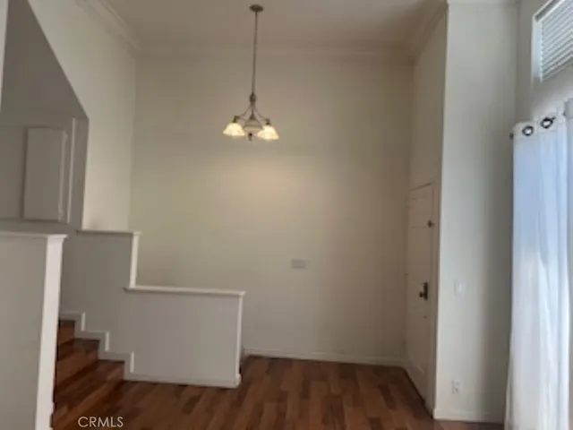 a view of a room with wooden floor and fan