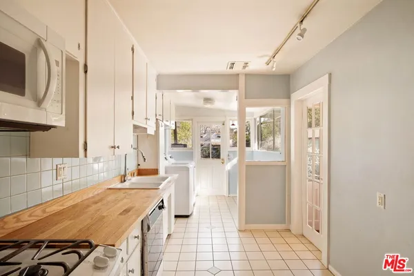 a spacious bathroom with a granite countertop sink and a mirror