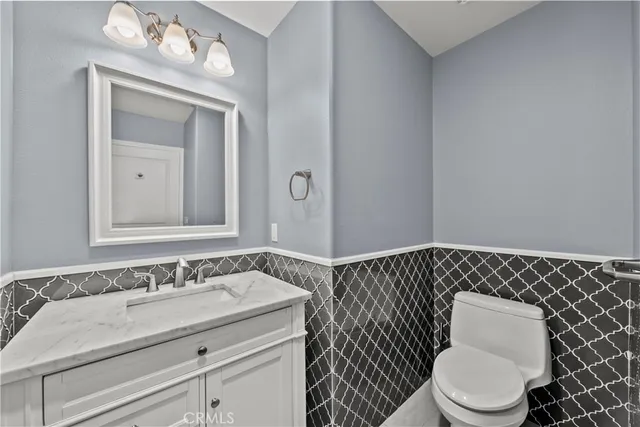 a living room with furniture potted plant and a large window