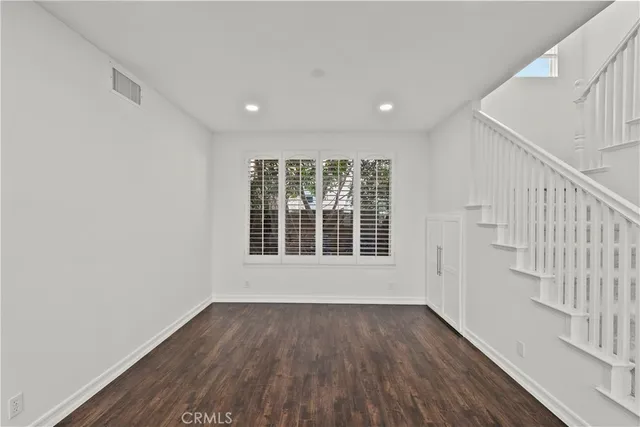 a kitchen with white cabinets and sink
