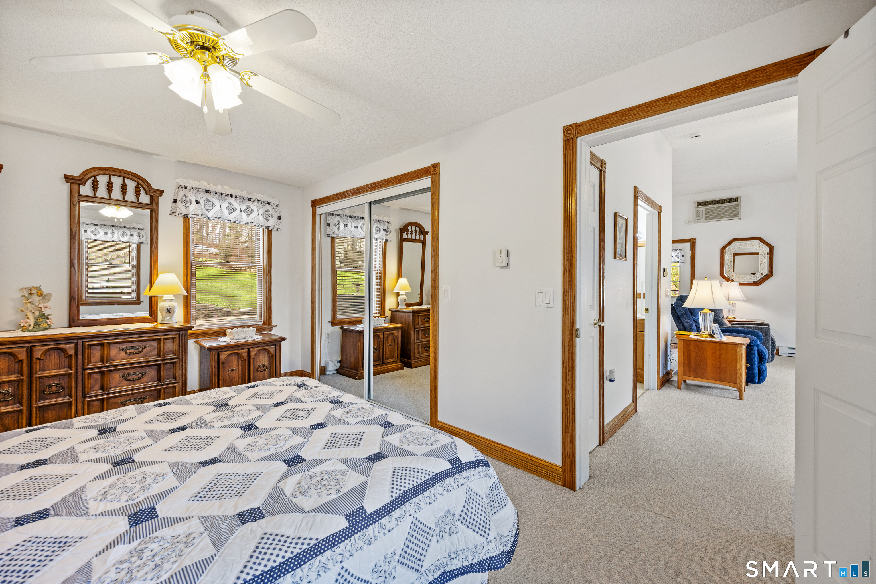 42 Chimney Sweep Road Wallingford, CT 06492 - Photo 38 of 40 a bedroom with a bed and dresser with mirror