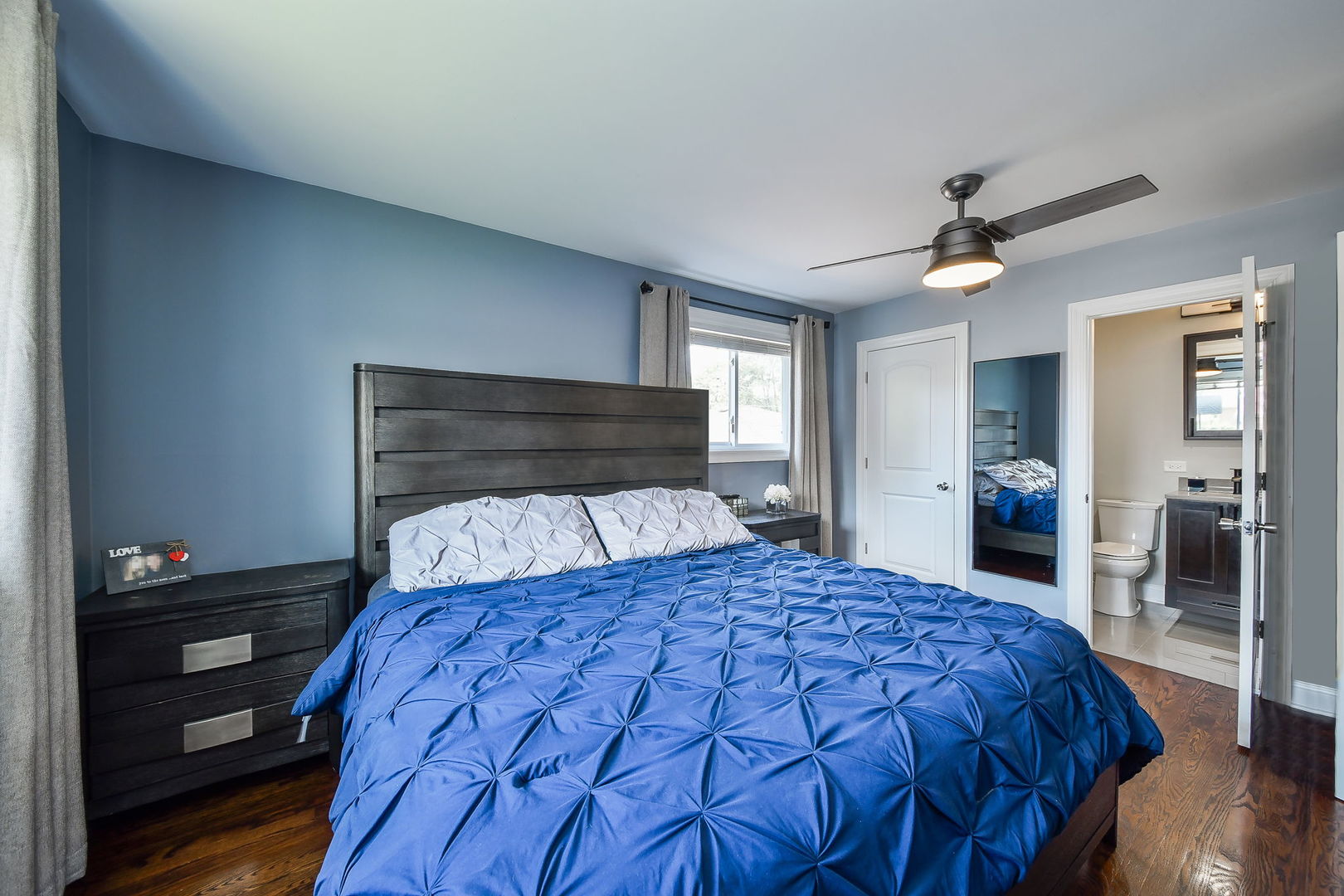 744 Neva Avenue Addison, IL 60101 - Photo 12 of 27 a bedroom with a large bed and a chandelier