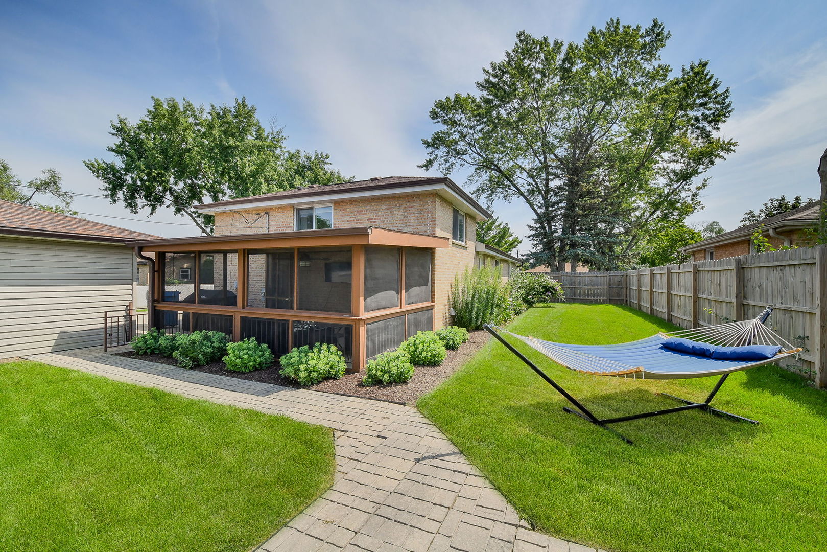 744 Neva Avenue Addison, IL 60101 - Photo 19 of 27 a view of a backyard with table and chairs and a barbeque
