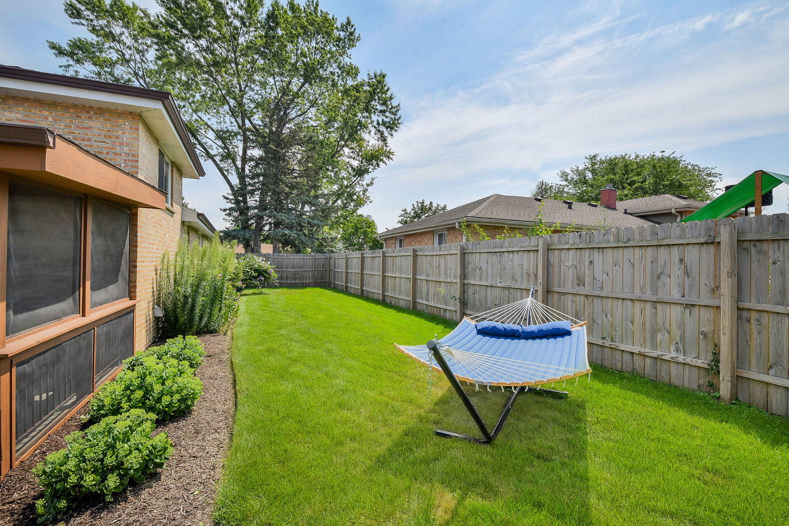 744 Neva Avenue Addison, IL 60101 - Photo 20 of 27 a view of a backyard with a garden and entertaining space
