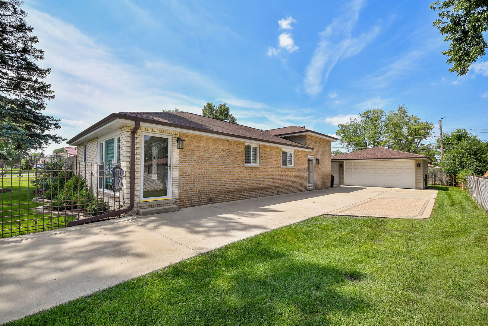 744 Neva Avenue Addison, IL 60101 - Photo 5 of 27 a front view of a house with a yard and garage
