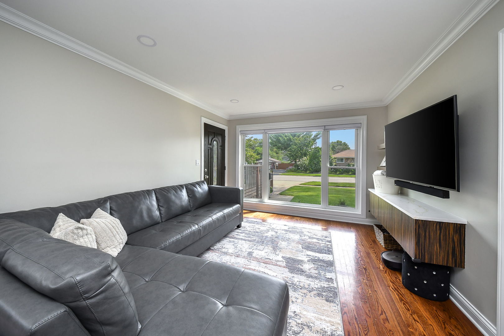 744 Neva Avenue Addison, IL 60101 - Photo 6 of 27 a living room with furniture and a flat screen tv