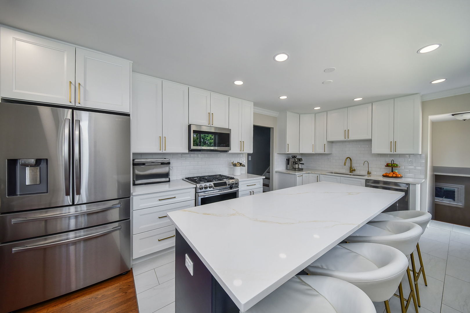 744 Neva Avenue Addison, IL 60101 - Photo 8 of 27 a kitchen with stainless steel appliances a refrigerator stove microwave and cabinets