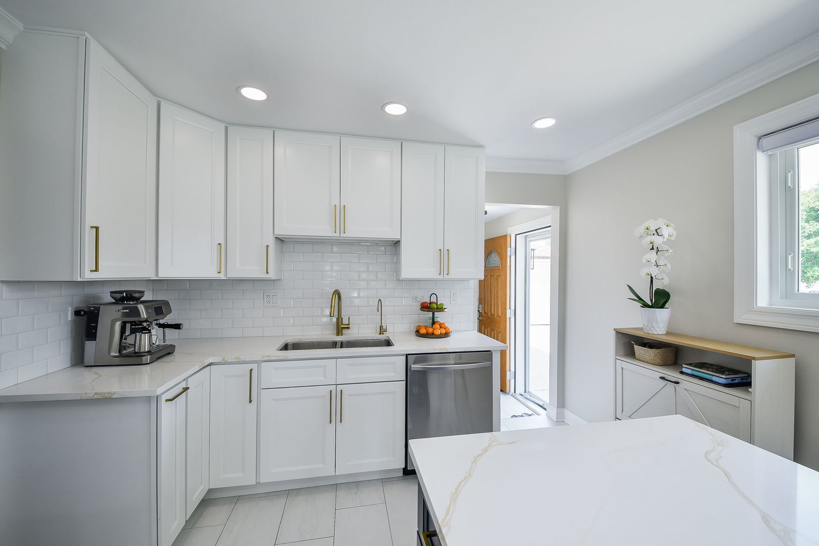 744 Neva Avenue Addison, IL 60101 - Photo 10 of 27 a room with white cabinets and clock