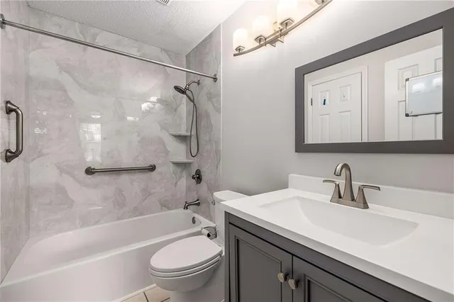 a bathroom with a sink a toilet and a bathtub