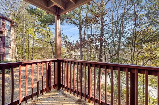 a view of balcony with wooden floor and fence