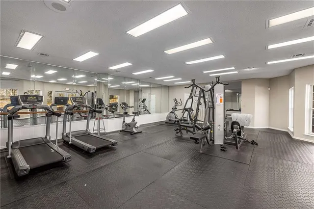 a view of a room with gym equipment and a large window