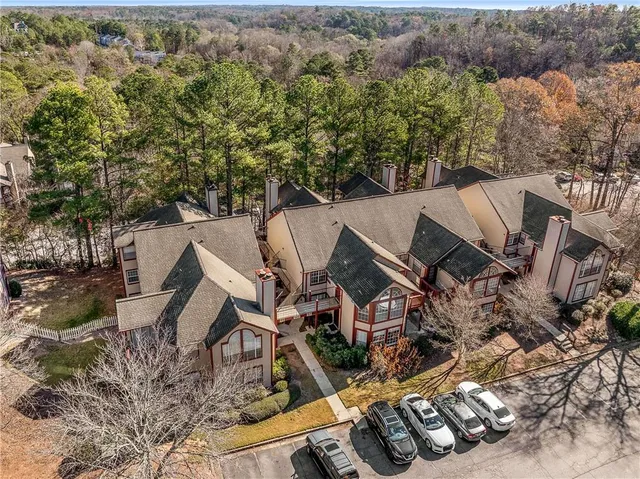 an aerial view of a house with garden space and trees