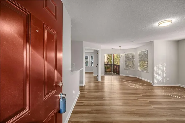 a view of an entryway with wooden floor