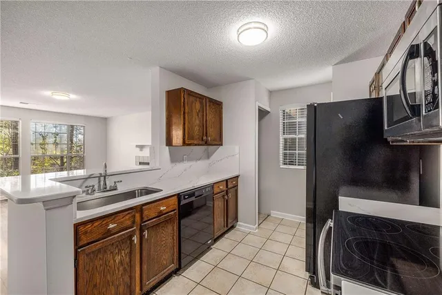 a kitchen with stainless steel appliances a sink stove and refrigerator