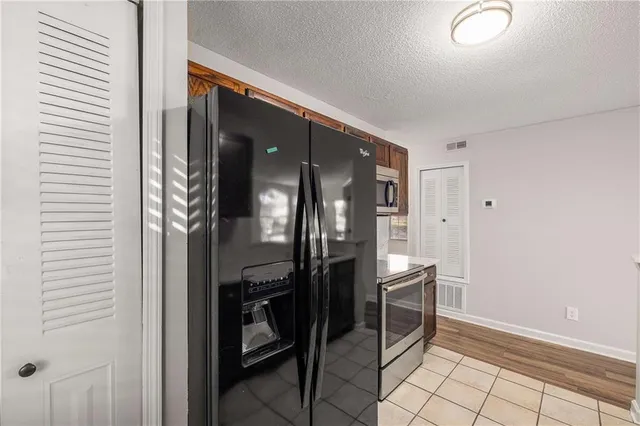 a view of empty room with wooden floor and fireplace