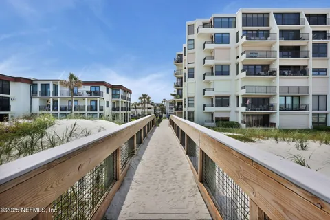 a view of balcony with a couple of cars parked in front of it