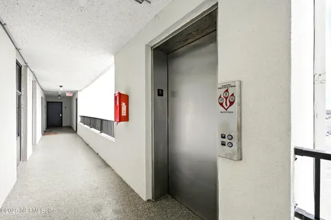 a hallway with painting on the wall