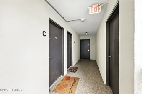 a view of a hallway with wooden shelves