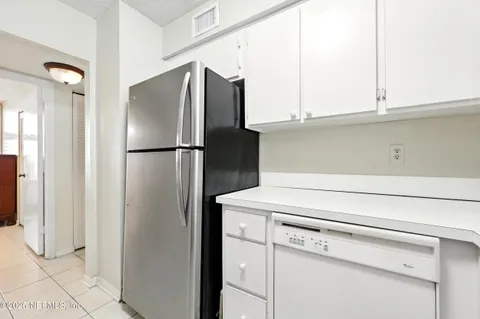 a close view of a refrigerator and cabinets