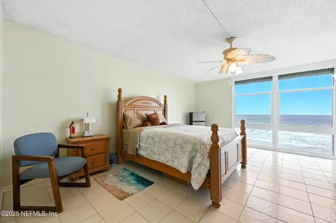 a bedroom with a bed and a chair